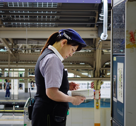 Tokyo, Japan - May 15, 2017. A female staff working at railway station in Tokyo, Japan. The Shinkansen is a network of high-speed railway lines in Japan operated by five Japan Railways Group.のeditorial素材