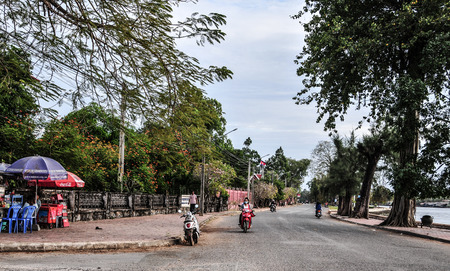 Kampot, Cambodia - Dec 31, 2011. People riding scooters on street in Kampot, Cambodia. Kampot is a small town in south-east Cambodia, and is a gateway to Bokor National Park.のeditorial素材