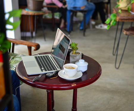 Dalat, Vietnam - Aug 18, 2017. A Macbook on wooden table at coffee shop in Dalat, Vietnam. Da Lat is a popular tourist destination in Southern Vietnam.のeditorial素材