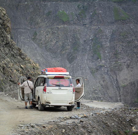 Kashmir, India - Jul 23, 2015. A car stopping on mountain road with valley in Jammu and Kashmir, India. Jammu and Kashmir is the only state in India with a Muslim-majority population.のeditorial素材