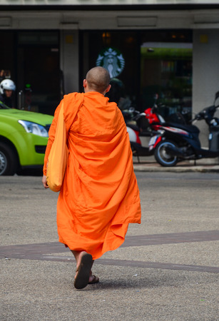 A monk walking on street in Chiang Mai, Thailand. Chiang Mai sometimes written as Chiengmai, is the largest city in northern Thailand.の写真素材