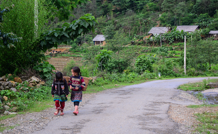 People walking on mountain road in Mai Chau, Vietnam.のeditorial素材