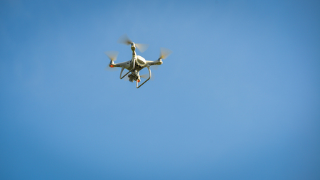 Close-up of a drone against the blue sky at sunny day in spring time.の写真素材