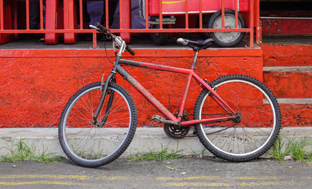 Vintage bicycle against old brick wall in Mahebourg, Mauritius.の写真素材
