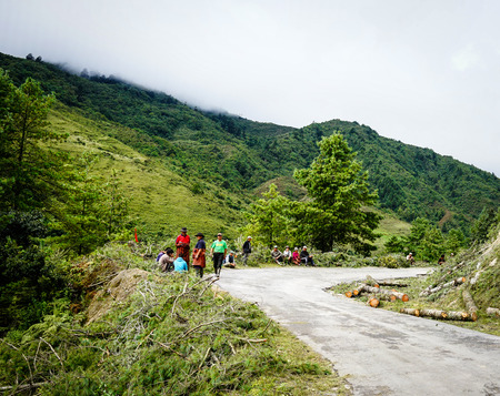 Thimphu, Bhutan - Sep 1, 2015. People walking on rural road in Bhutan. In South Asia, Bhutan ranks first in economic freedom, ease of doing business, and peace.のeditorial素材