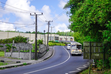 Port Louis, Mauritius - Jan 6, 2017. Vehicles running on rural road at sunny day in Port Louis, capital of Mauritius. Port Louis is the business and administrative capital of the island.のeditorial素材