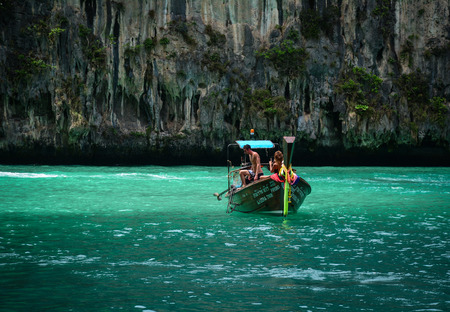 Krabi, Thailand - Jun 20, 2016. Tourists on the traditional wooden boat in Koh Phi Phi, Thailand. Phi-Phi Island is one of the most talked about places in Southeast Asia.のeditorial素材