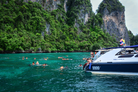 Krabi, Thailand - Jun 20, 2016. People swimming on the blue sea at summer in Koh Phi Phi, Thailand....