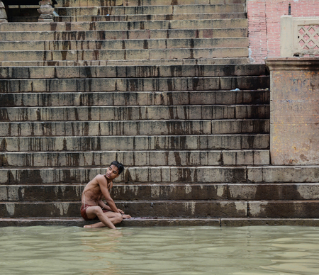Varanasi, India - Jul 12, 2015. A young man bathing on the Ganges River in Varanasi, India. Varanasi, also known as Kashi and Benaras, is the cultural capital of India.のeditorial素材