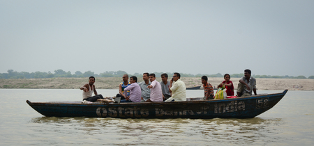 Varanasi, India - Jul 12, 2015. Tourist boat on the Ganges River at rainy day in Varanasi, India. Varanasi, also known as Kashi and Benaras, is the cultural capital of India.のeditorial素材