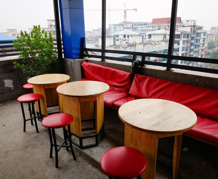 Chairs and tables at coffee shop with city view in Yangon, Myanmar.の写真素材