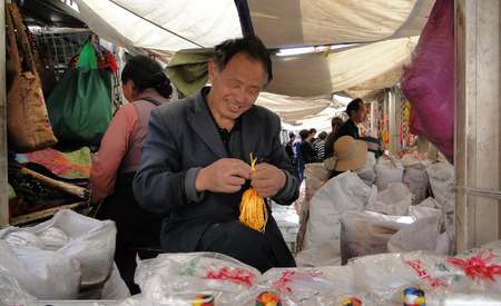 Tibet, China - Sep 7, 2012. Portrait of vendor at Jokhang temple in Tibet. The Jokhang Temple in Lhasa, Tibet has two Buddha statues sacred to Tibetan Buddhists.のeditorial素材