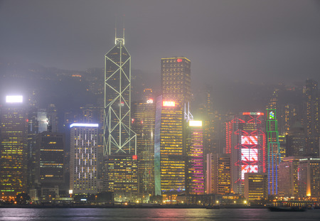 Hong Kong - Mar 29, 2017. Many buildings at night in Hong Kong, China. Hong Kong gross domestic...
