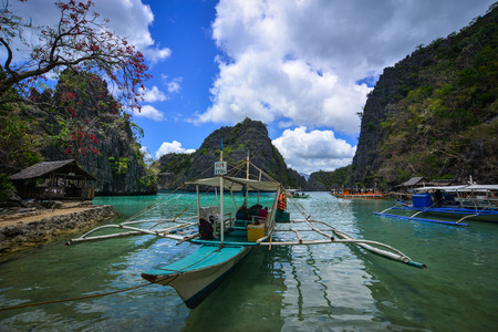 Coron, Philippines - Apr 9, 2017. Wooden boats docking at pier in Coron Island, Philippines. Coron is known for several Japanese shipwrecks of World War II vintage.のeditorial素材