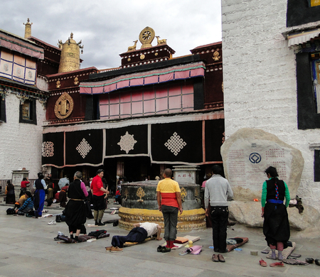 Tibet, China - Sep 5, 2010. Pilgrims praying in front of Jokhang Temple in Lhasa, Tibet. The Jokhang Temple has two Buddha statues sacred to Tibetan Buddhists.のeditorial素材