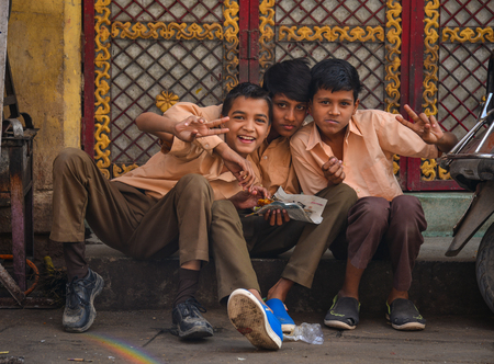 Jodhpur, India - Nov 6, 2017. Indian boys sitting on street in Jodhpur, India. Jodhpur is a popular tourist destination, featuring many palaces, forts and temples.のeditorial素材