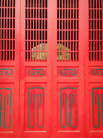Red wooden door of ancient Buddhist pagoda in Hualien, Taiwan.の写真素材