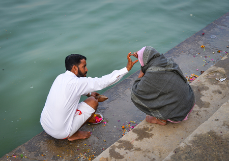 Pushkar, India - Nov 5, 2017. Indian people bathing and praying near the holy lake in Pushkar, India. Pushkar is a town in the Ajmer district in the state of Rajasthan.のeditorial素材