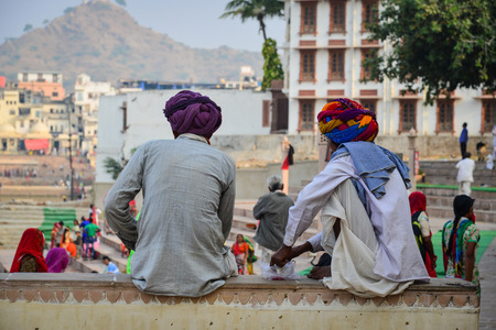 Indian men sitting and chatting on street in Pushkar, India.のeditorial素材