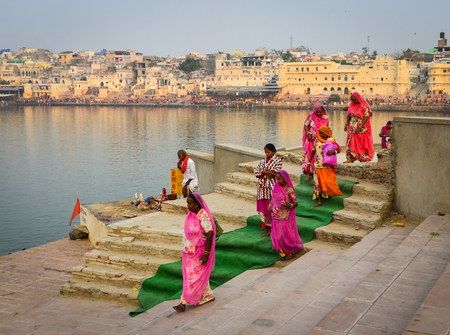 Pushkar, India - Nov 5, 2017. Hindu pilgrims walking and praying near the holy lake in Pushkar, India. Pushkar is a town in the Ajmer district in the state of Rajasthan.のeditorial素材