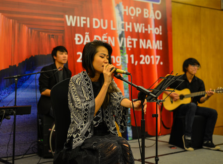 Saigon, Vietnam - Nov 20, 2017. A singer with microphone and rock and roll band performing hard rock music on stage in Saigon, Vietnam.のeditorial素材