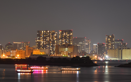Tokyo, Japan - May 20, 2017. Modern buildings at night in Tokyo, Japan. Tokyo was rated by the Economist Intelligence Unit as the most expensive (highest cost-of-living) city in the world.のeditorial素材