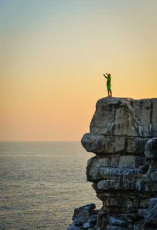A man standing on the rock at twilight in Tho Chau Islands (Poulo Panjang), Vietnam.の写真素材