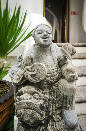 Chinese guardian figure at a gate in Wat Pho Bangkok, Thailand.の写真素材