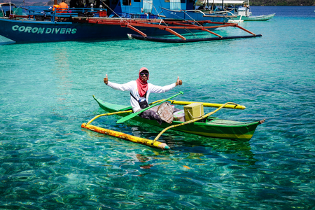 Palawan, Philippines - Apr 11, 2017. A local man rowing boat on sea in Palawan, Philippines. Palawan is one of the Philippine Islands top vacation destinations for foreign tourists.のeditorial素材