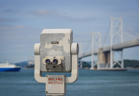 Okayama, Japan - Oct 5, 2017. Coin-operated binoculars against the Great Seto Bridge in Okayama, Japan.のeditorial素材