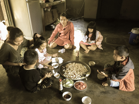 Lam Dong, Vietnam - Dec 30, 2017. Children sitting and eating at a rural house in Lam Dong Province, Vietnam.のeditorial素材