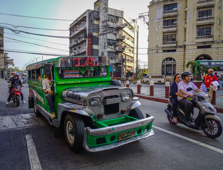 Manila, Philippines - Apr 12, 2017. Jeepneys on main street in Manila, Philippines. Manila is the capital of the Philippines and the center of governance, education and finance.のeditorial素材
