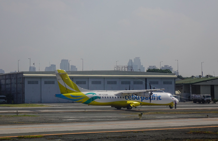 Manila, Philippines - Apr 12, 2017. A civil aircraft on runway at Ninoy Aquino Airport (NAIA) in Manila, Philippines. In 2015, NAIA handled a record breaking annual passenger traffic of 36,681,601.のeditorial素材