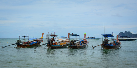 Phuket, Thailand - Jun 19, 2016. Wooden boats on the blue sea in Phuket, Thailand. Phuket Island is home to many high-end seaside resorts, spas and restaurants.のeditorial素材