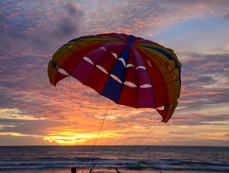 Parasailing in the mystery sky at sunset on Patong Beach of Phuket, Thailand.