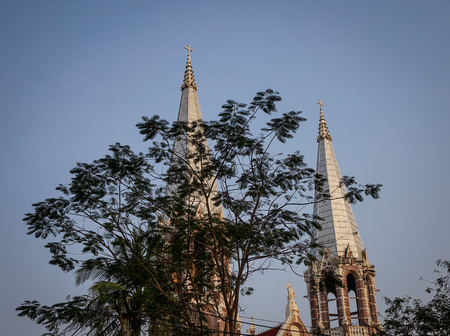 Top of ancient church with trees in Yangon, Myanmar.の写真素材
