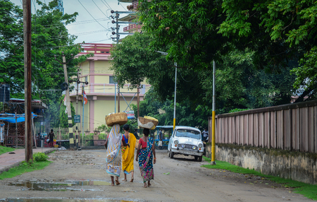 Bodhgaya, India - Jul 9, 2015. Local women walking on street in Bodhgaya, India. Bodh Gaya is considered one of most important Buddhist pilgrimage sites.のeditorial素材