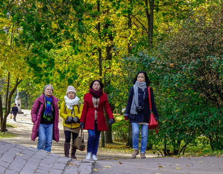 Vyborg, Russia - Oct 6, 2016. Women walk at autumn park in Vyborg, Russia. Vyborg stands at the head of Vyborg Bay of the Gulf of Finland, 113 km northwest of St. Petersburg.のeditorial素材
