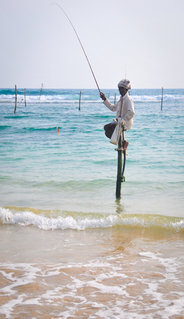 Hikkaduwa, Sri Lanka - Feb 1, 2012. Stilt Fishermen of Sri Lanka. Stilt fishing is a method of fishing unique to the island country of Sri Lanka, located off the coast of India.のeditorial素材