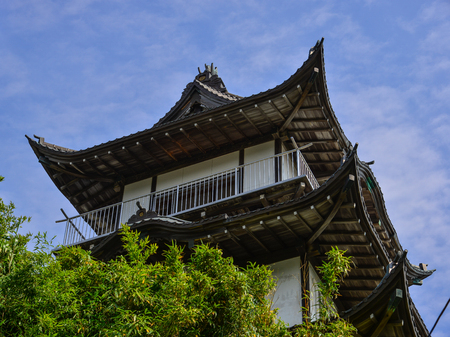 Wooden tower of ancient Japanese temple under blue sky.のeditorial素材