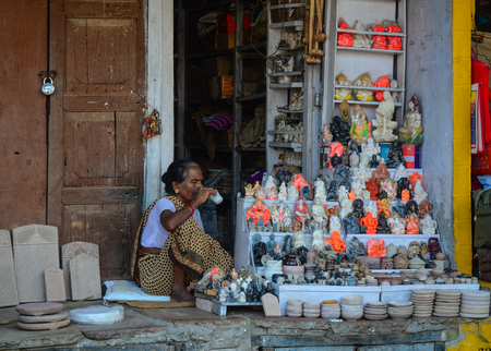 Varanasi, India - Jul 12, 2015. A vendor at street market in Varanasi, India. Varanasi is the holiest of the seven sacred cities (Sapta Puri) in Buddhism, Hinduism and Jainism.のeditorial素材