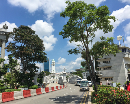 Singapore - Mar 12, 2016. Cars on street at downtown in Singapore. Singapore is a global financial...