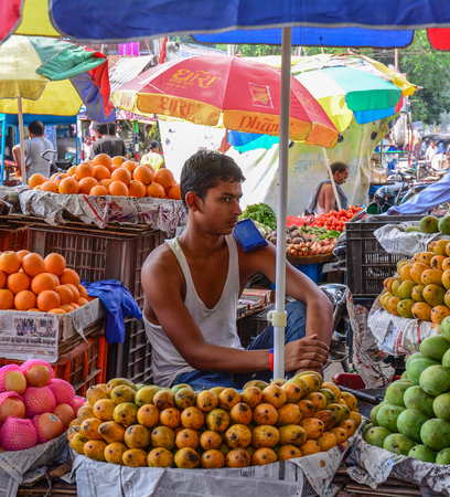 Bodhgaya, India - Jul 9, 2015. A man selling fruits at street market in Bodhgaya, India. Bodh Gaya is considered one of the most important Buddhist pilgrimage sites.のeditorial素材