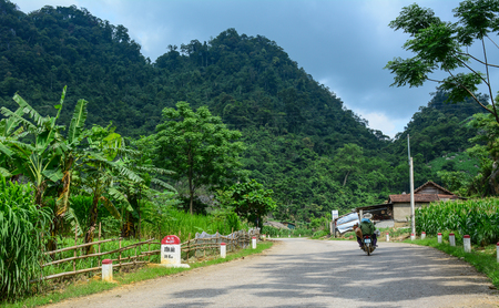 Moc Chau, Vietnam - May 27, 2016. A motorbike running on mountain road in Moc Chau, Vietnam. Moc Chau is a rural district of Son La Province in the Northwest region of Vietnam.のeditorial素材