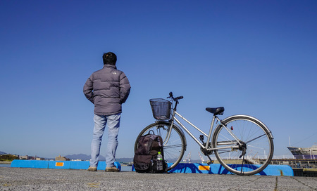 Hakodate, Japan - Oct 1, 2017. A traveler with bicycle at Port of Hakodate, Japan. Hakodate opened its gates to the world as Japan first international trade port in 1859.のeditorial素材