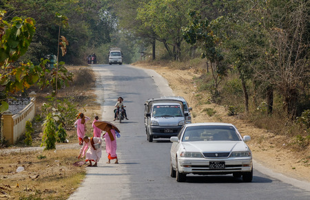 Yangon, Myanmar - Feb 21, 2016. Buddhist nuns walking on rural road in Yangon, Myanmar. Yangon, also called Rangoon, city, capital of independent Myanmar from 1948 to 2006.のeditorial素材