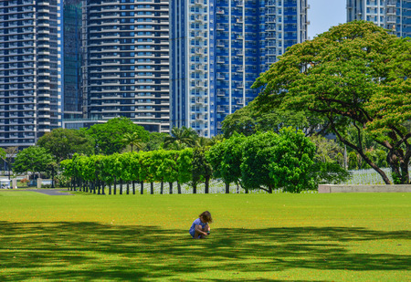 Manila, Philippines - Apr 13, 2017. A girl playing at Manila American Cemetery. Cemetery honors the American and allied servicemen who died in World War II.のeditorial素材