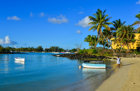Mahebourg, Mauritius - Jan 9, 2017. A woman walking on beach in Mahebourg, Mauritius. Mauritius is a major tourist destination, ranking 3rd in the region.のeditorial素材