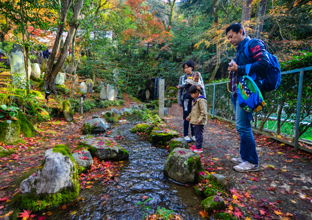 Kyoto, Japan - Nov 28, 2016. A family visit autumn park in Kyoto, Japan. Kyoto was the capital of Japan for over a millennium, and carries a reputation as its most beautiful city.のeditorial素材