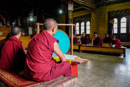 Thimphu, Bhutan - Aug 30, 2015. Young monks praying at monastery in Thimphu, Bhutan. It is believed...